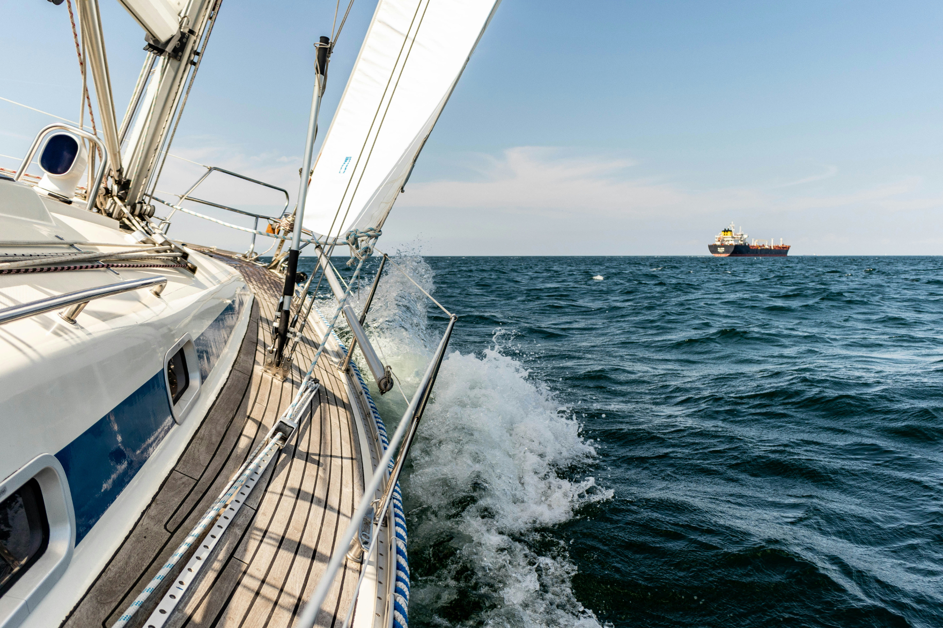 Sailing yacht heeling on open ocean — a metaphor for charting capital across cycles